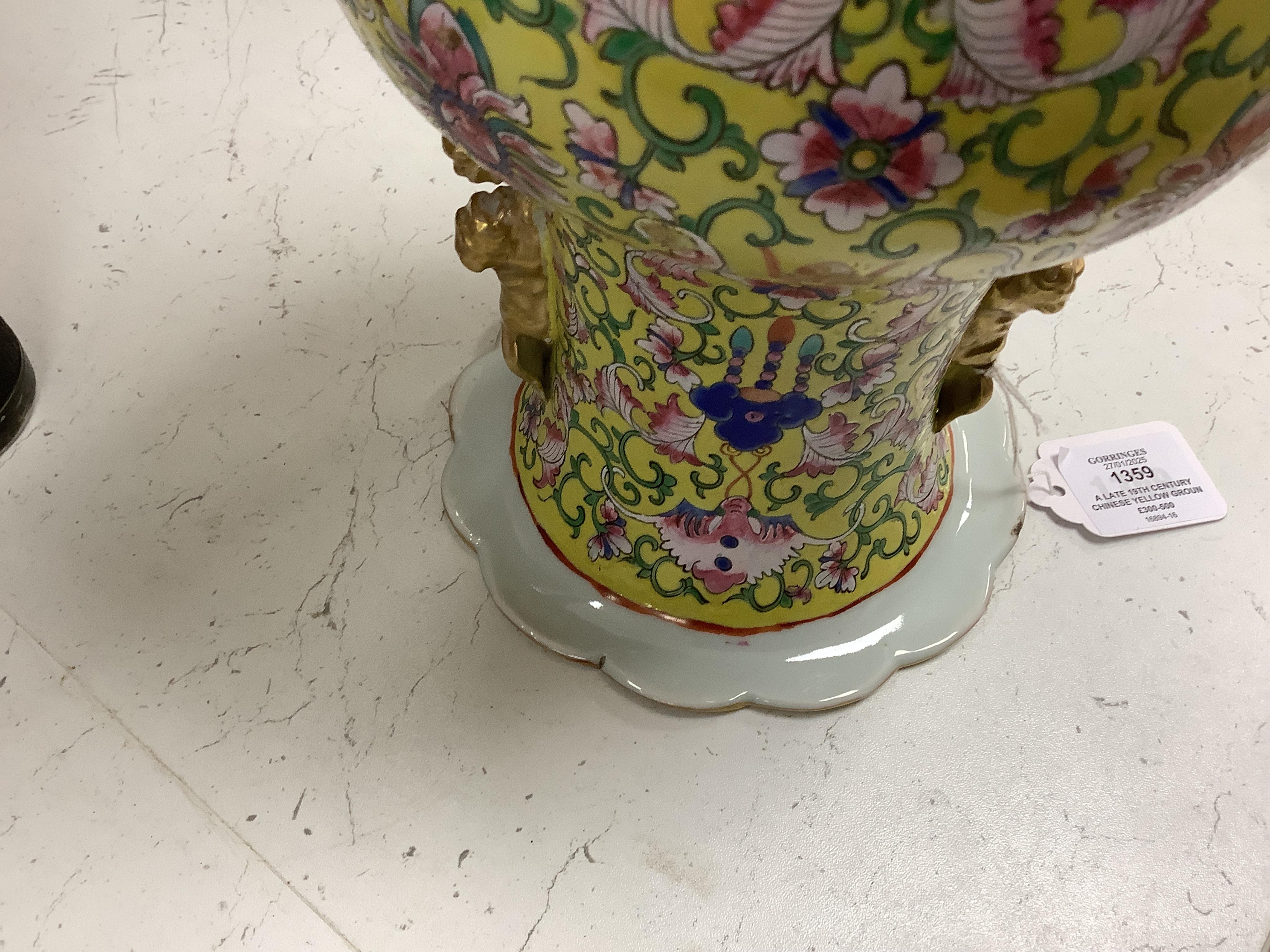 A late 19th century Chinese yellow ground porcelain vase, with gilt chilong handle, decorated with flowers and tendrils, iron red bands to the scalloped neck (including two stands), 35cm high. Condition - chip to top edg